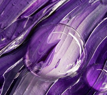 Close-up of a textured purple abstract artwork featuring clear bubbles.