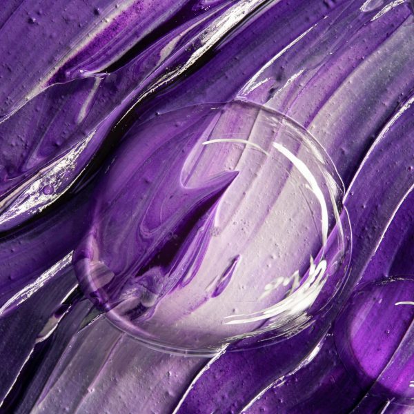 Close-up of a textured purple abstract artwork featuring clear bubbles. Close-up of a textured purple abstract artwork featuring clear bubbles.