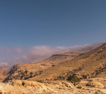 Explore the breathtaking arid landscape of Shobak, Jordan with stunning mountain views.
