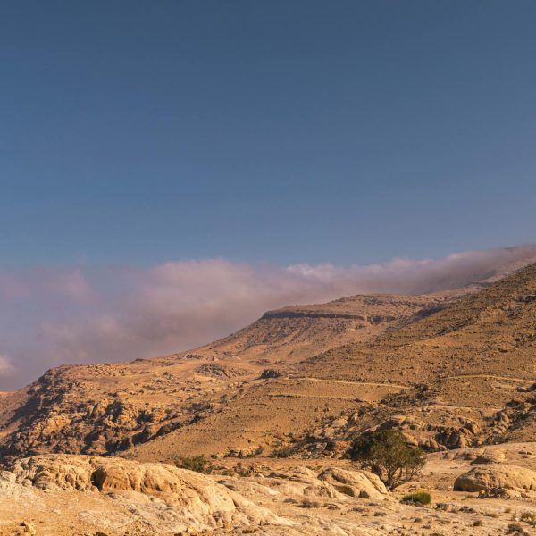 Explore the breathtaking arid landscape of Shobak, Jordan with stunning mountain views.